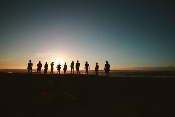 people standing in sunset